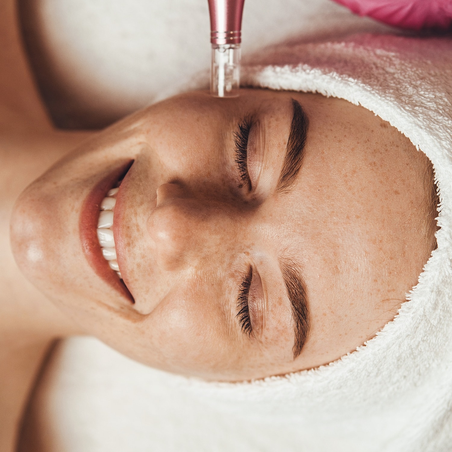 Woman enjoying a facial treatment with tools.