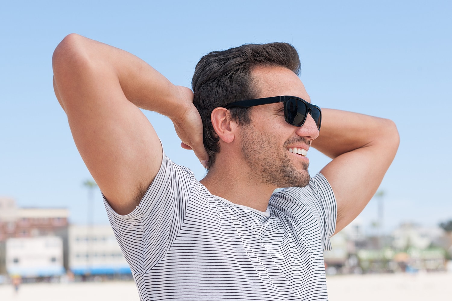 Smiling man enjoying a sunny beach day.